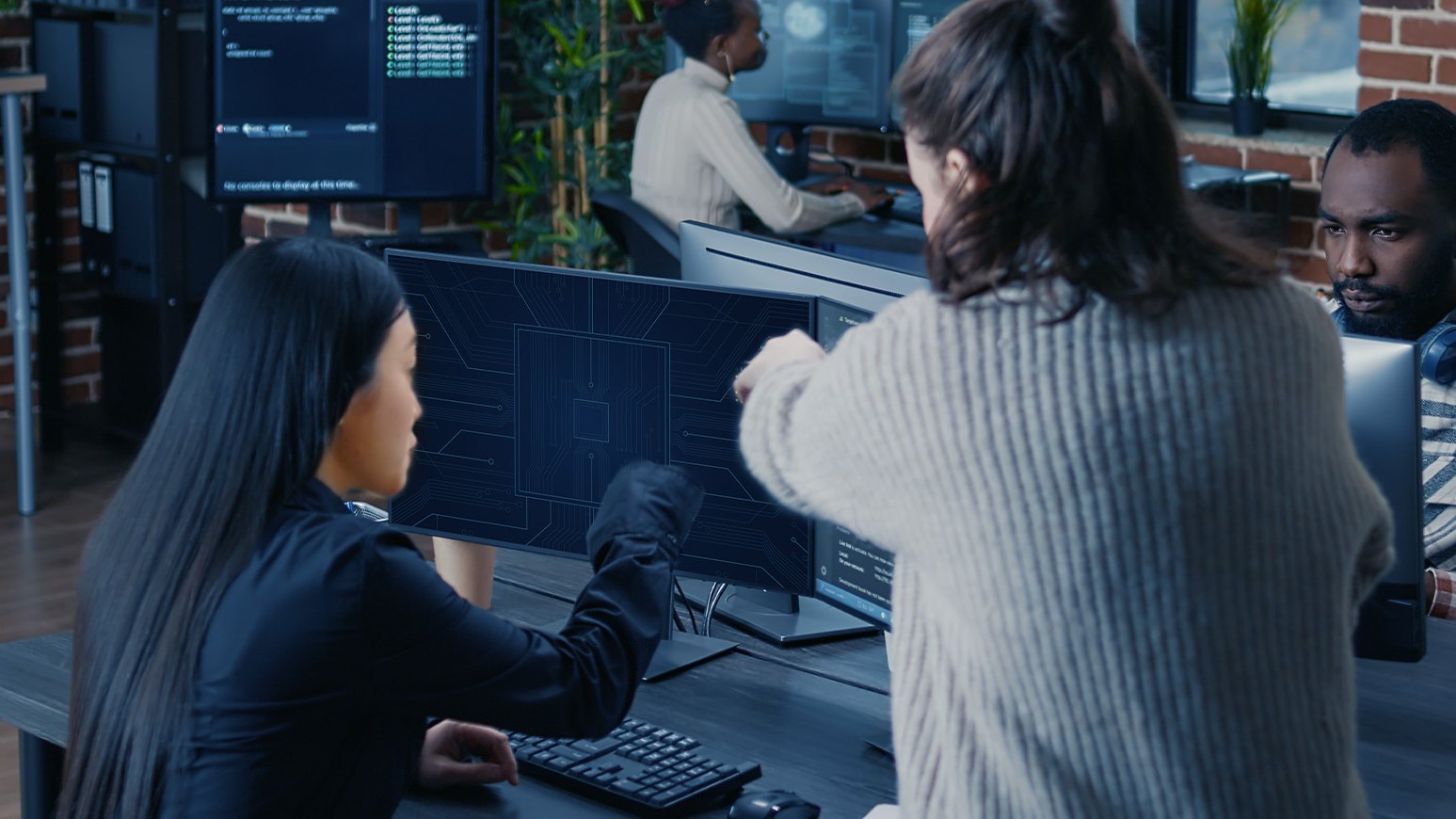 Engineers reviewing PCB design data on a screen